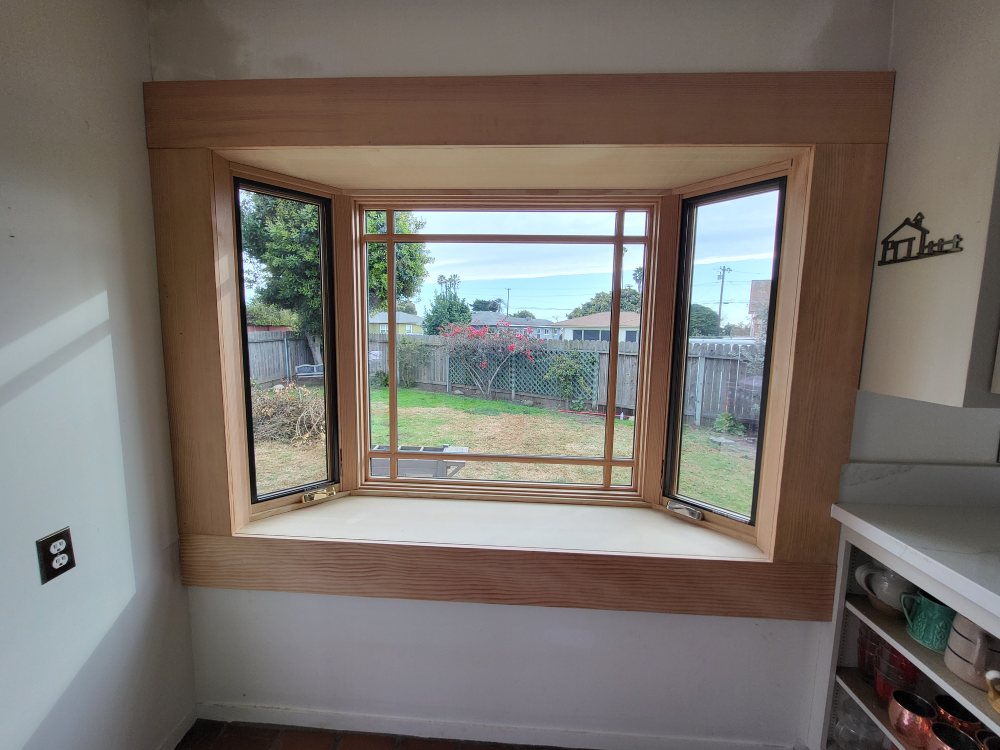 Windsor Pinnacle bay window with wood interior and aluminum-clad exterior complementing traditional home architecture