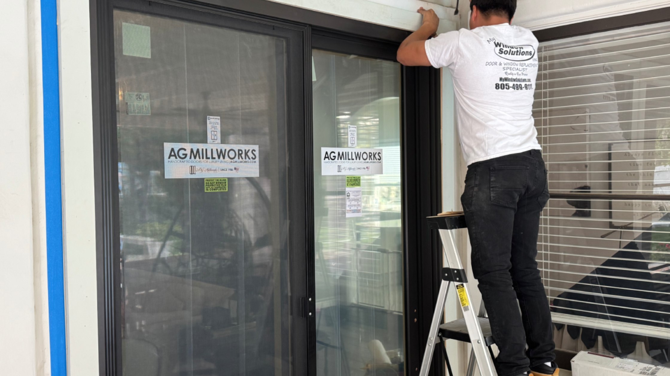 My Window Solutions technician repairing sliding door hardware and tracks.